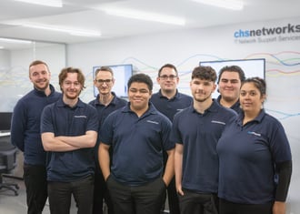 CHS networks Team photo downstairs with logo